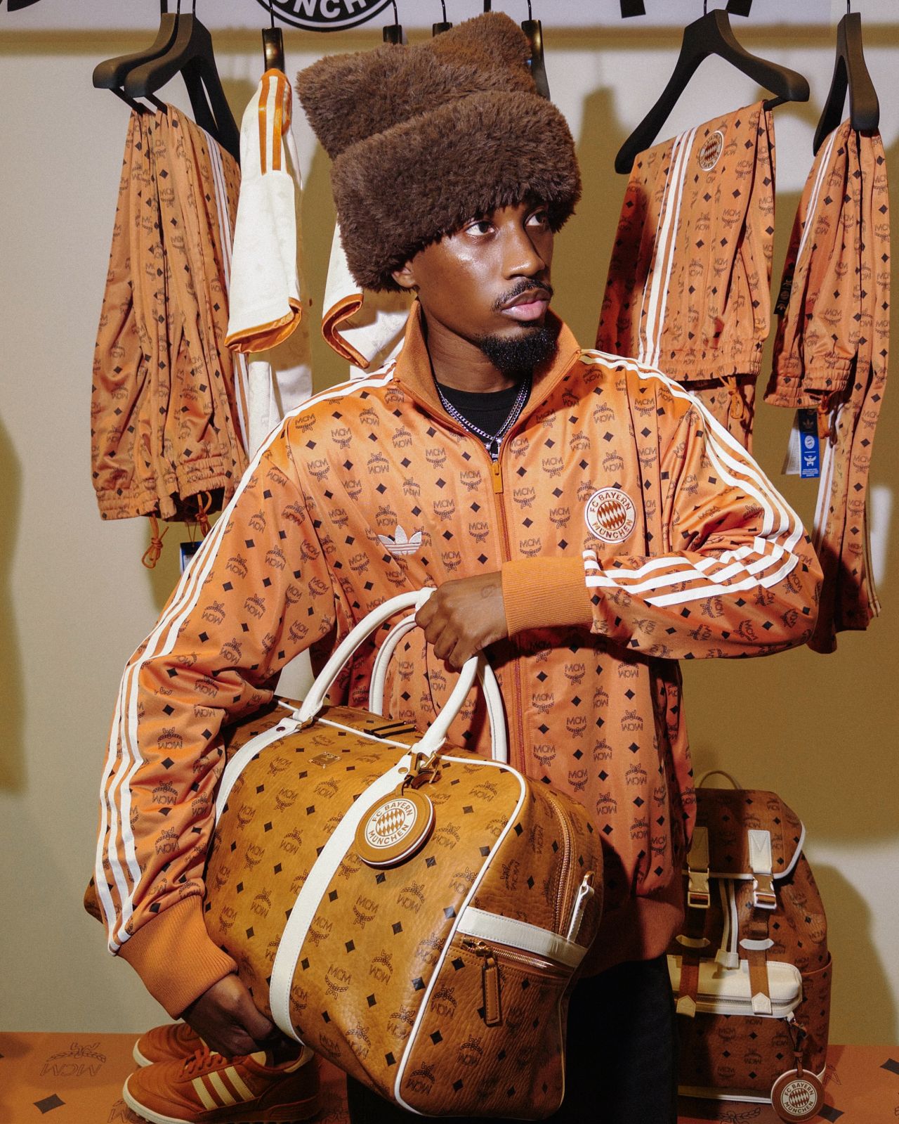 Guest wearing MCM and adidas apparel with a travel bag