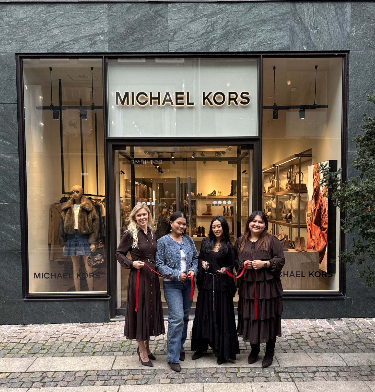 Michael Kors team outside a branded Copenhagen storefront