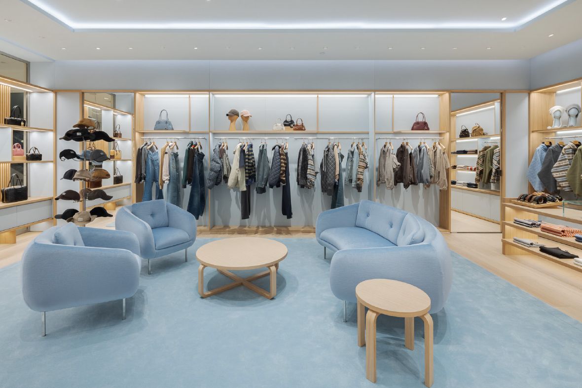 Blue seating and clothing rails at Miu Miu Saks Boston