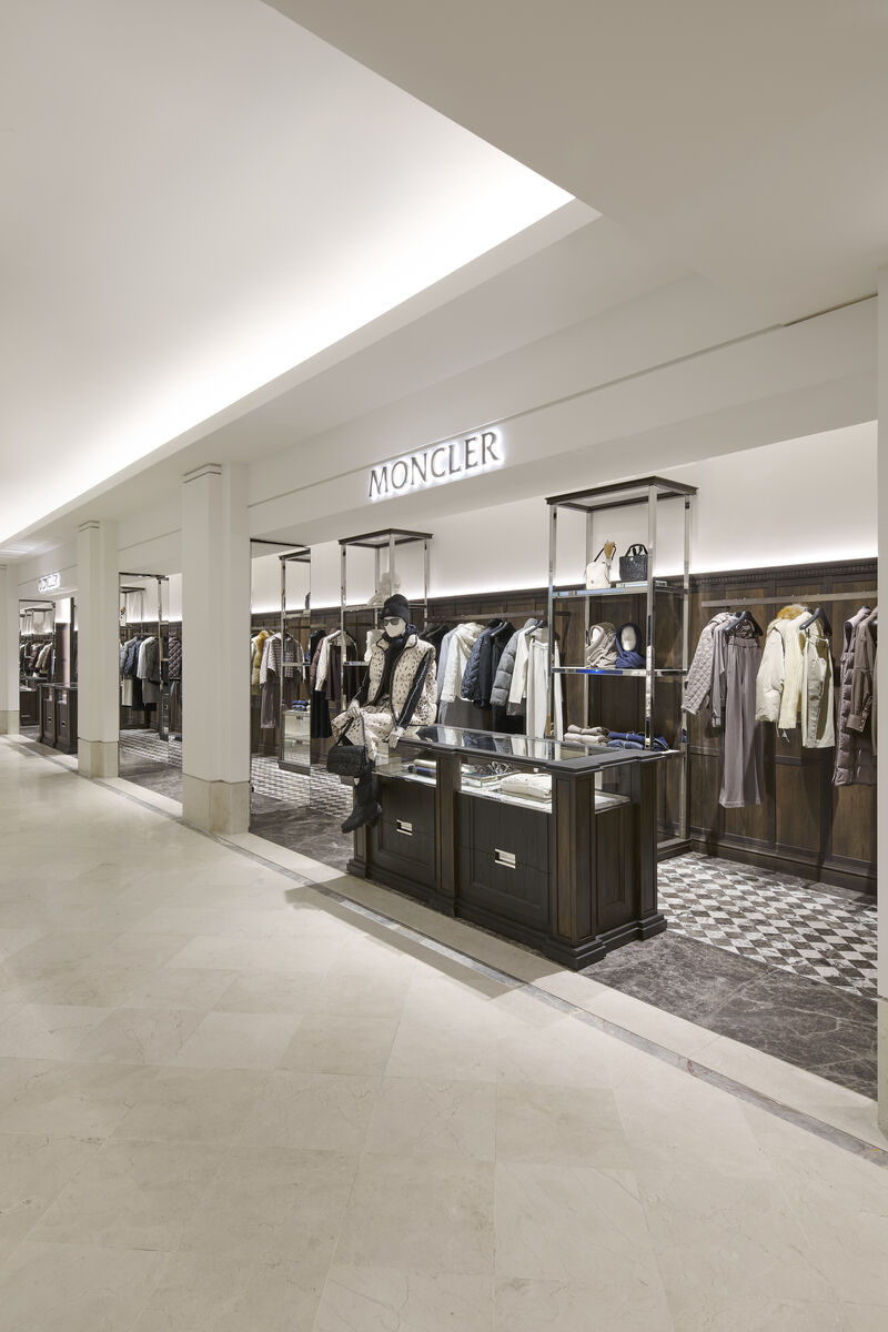 Open Moncler shop-in-shop viewed from the department-store aisle