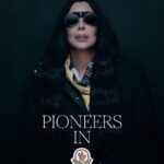Cher in black Moncler outerwear and a yellow scarf for Re/Icons