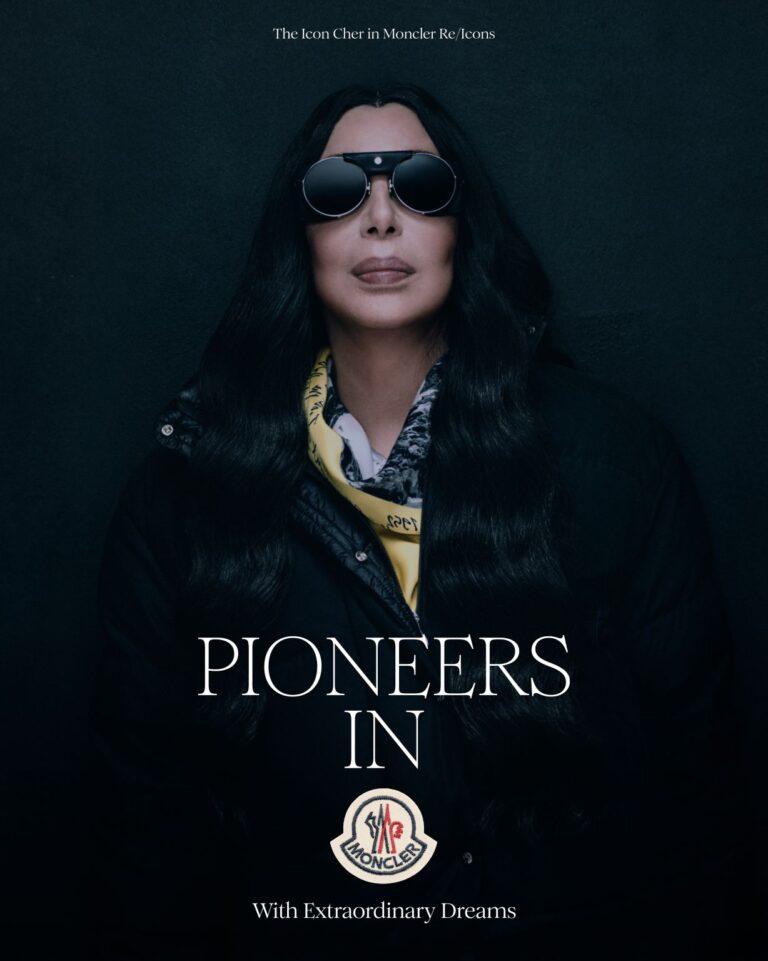Cher in black Moncler outerwear and a yellow scarf for Re/Icons