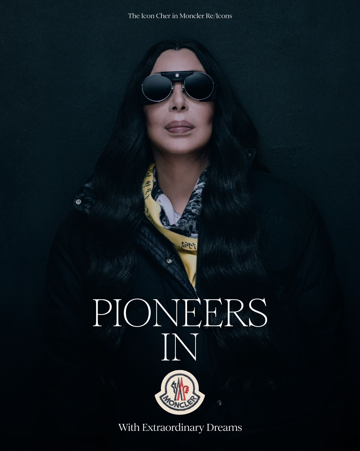Cher in black Moncler outerwear and a yellow scarf for Re/Icons