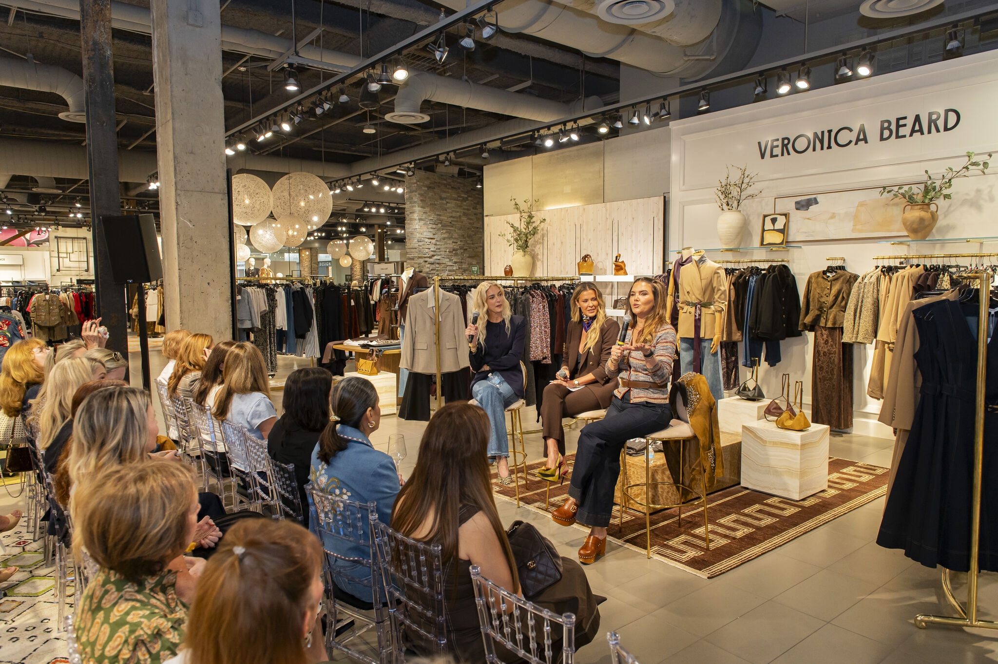 Veronica Beard co-founders with a guest inside the Neiman Marcus store