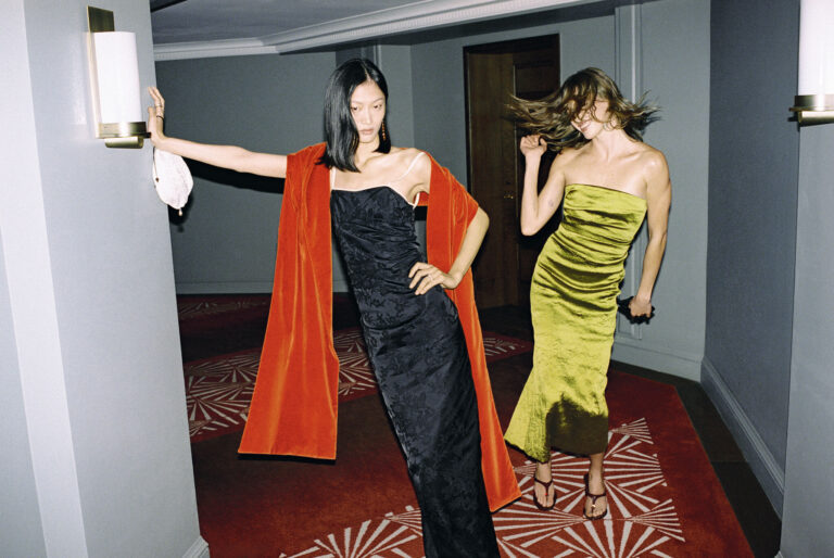 Models wearing black and green evening dresses in NET-A-PORTER holiday campaign