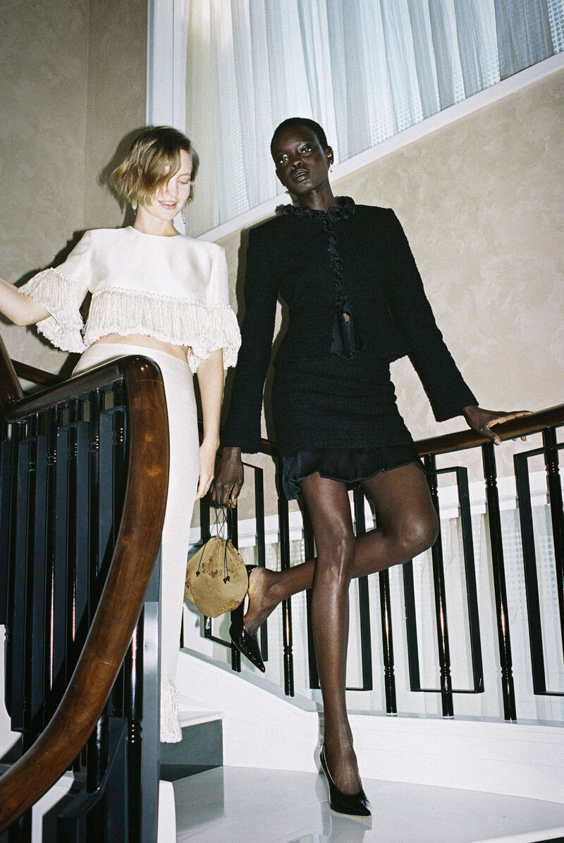 Two models in NET-A-PORTER holiday looks on a staircase