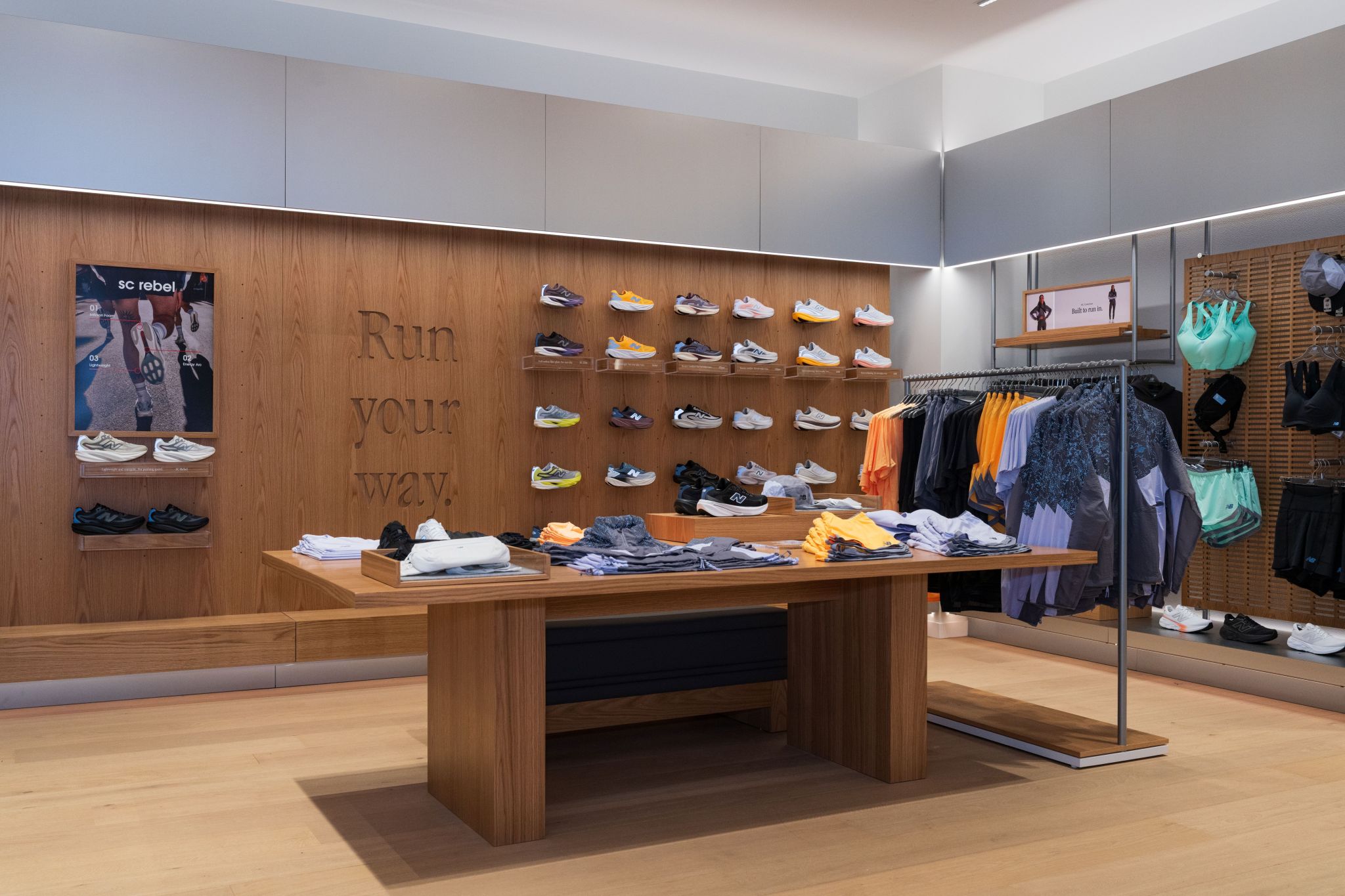 Footwear displays and timber tables inside the New Balance Auckland flagship