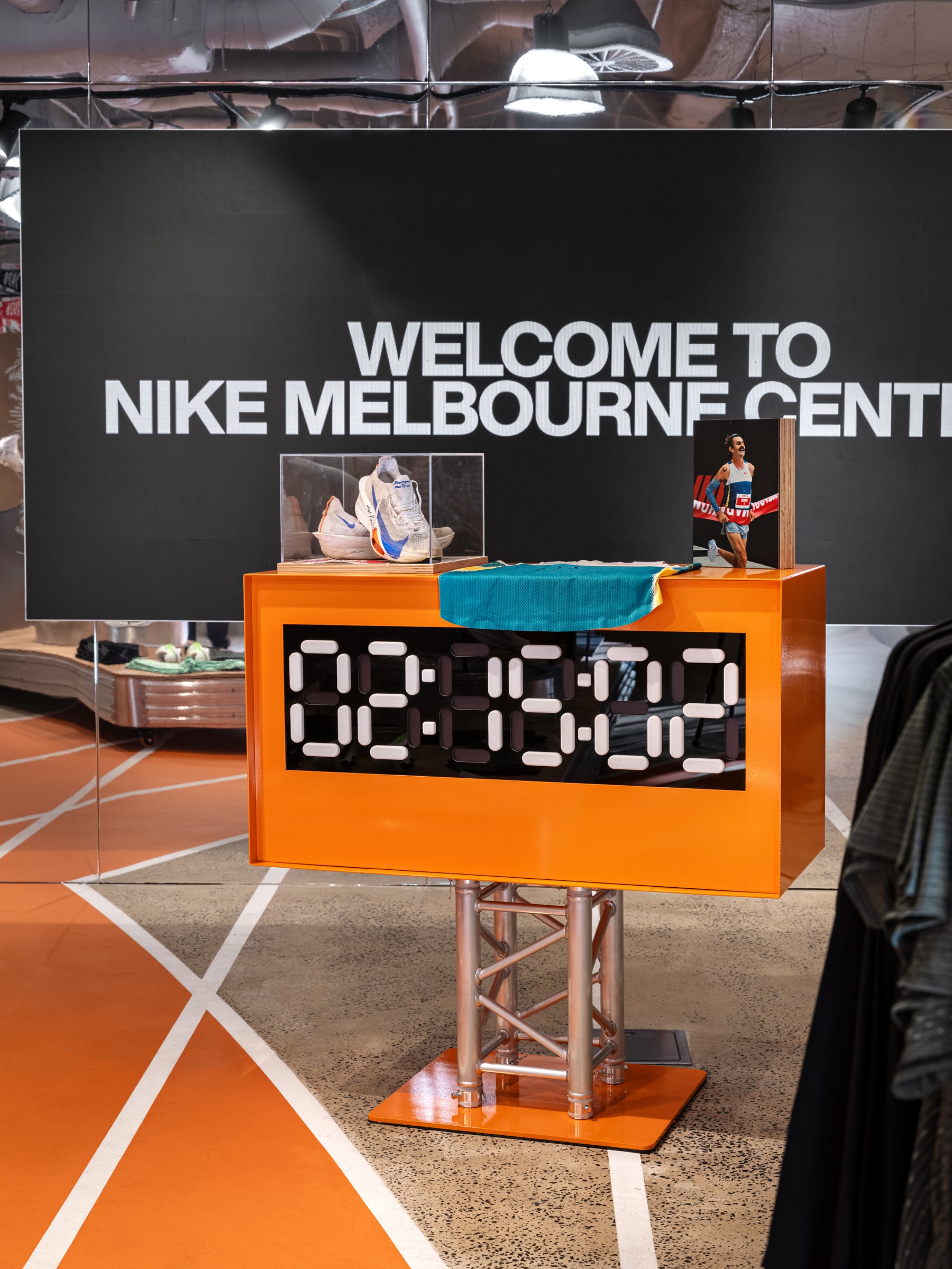 Nike Melbourne Central display featuring marathon footwear, apparel and a digital race clock.