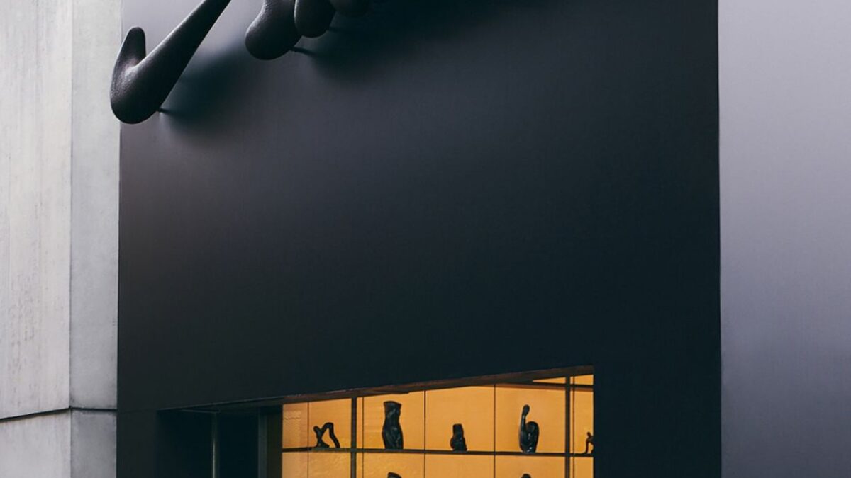 Sculptural Nike mark above a NikeSKIMS pop-up storefront