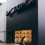 Sculptural Nike mark above a NikeSKIMS pop-up storefront