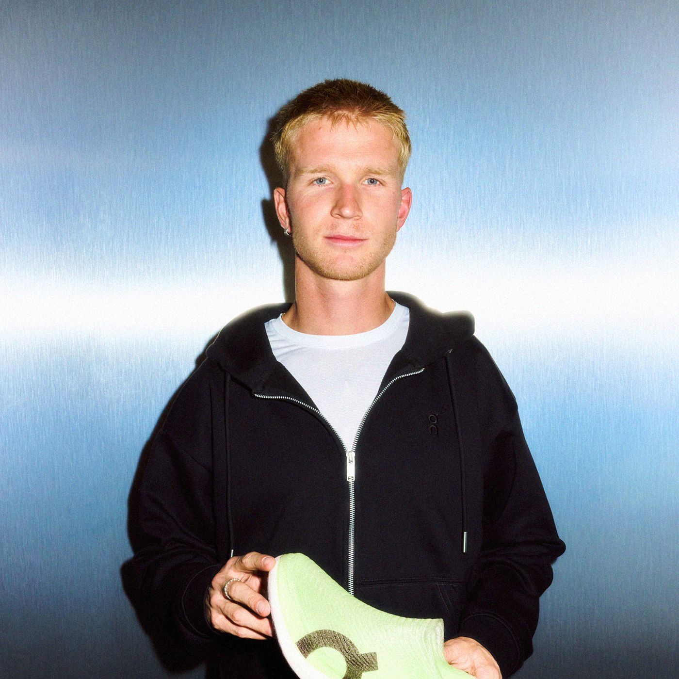 Event attendee holds an On LightSpray running shoe