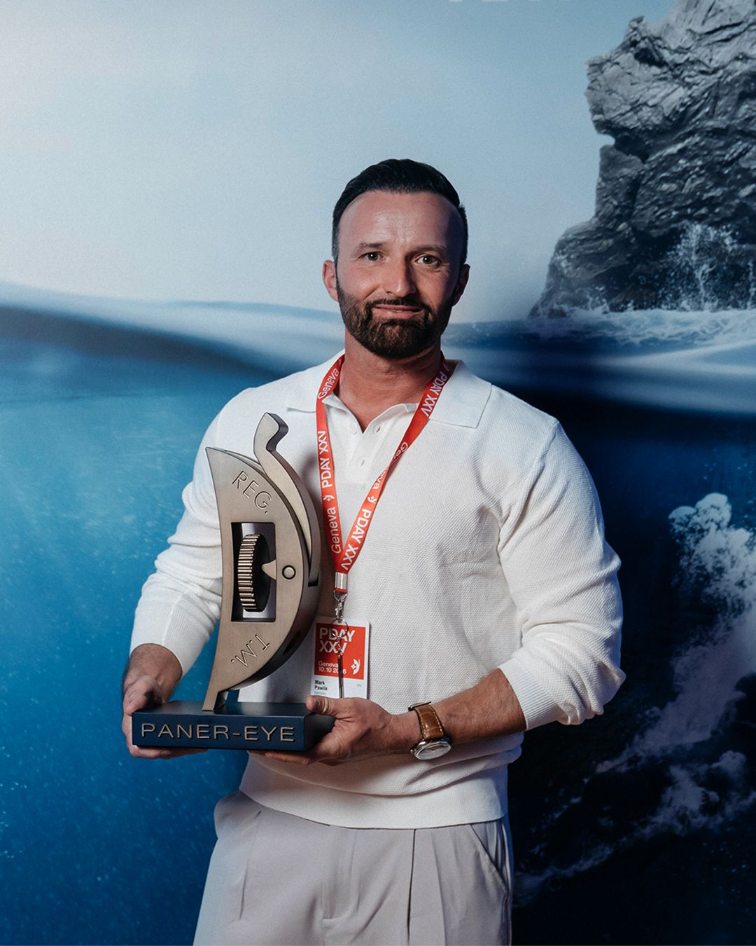 Guest holds an award at the Panerai P-Day gathering