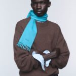 Model wearing Prada Re-Cashmere knitwear and a blue scarf