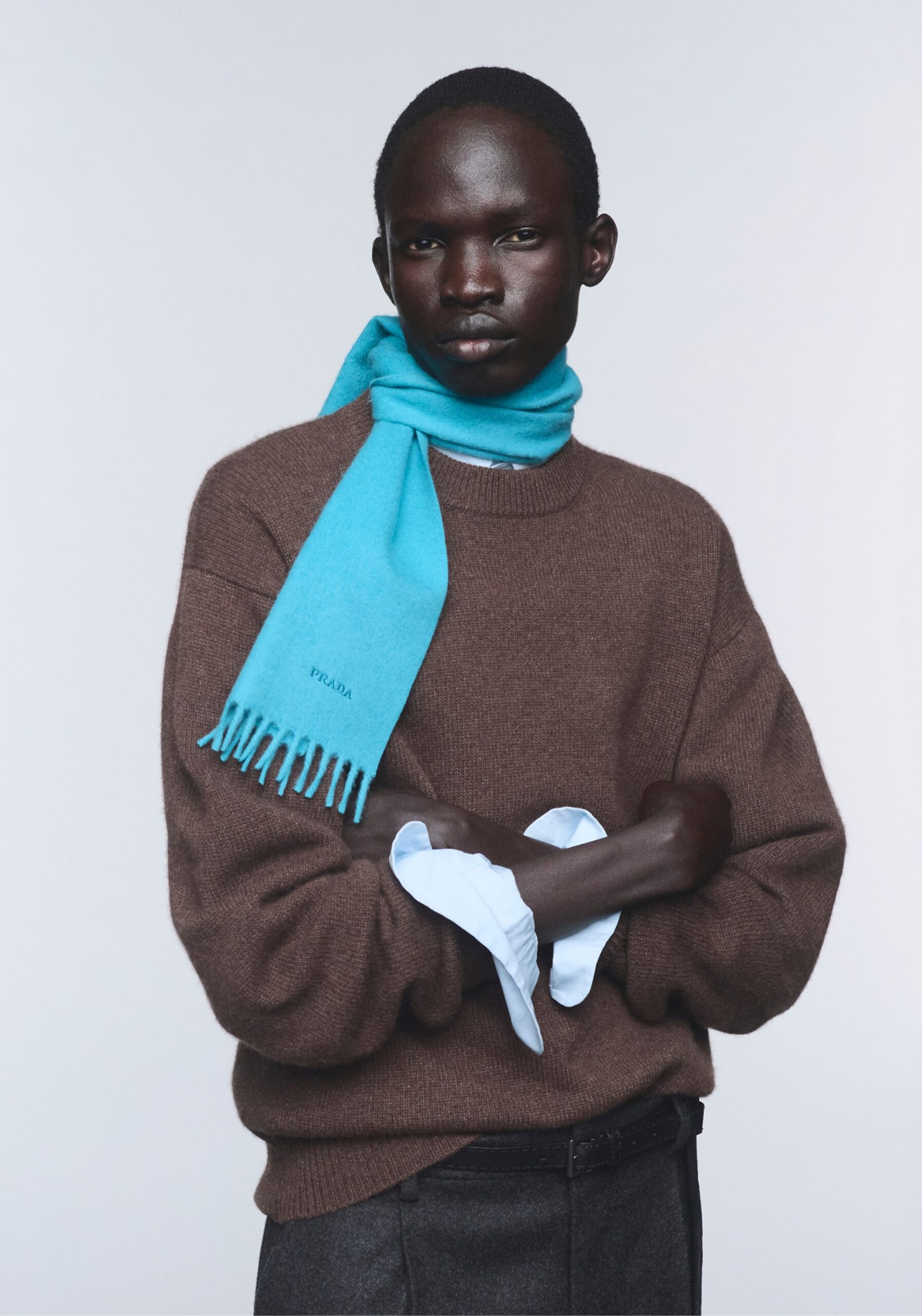 Model wearing Prada Re-Cashmere knitwear and a blue scarf