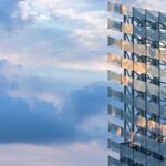 Reflective geometric building facade pictured in Puig’s third-quarter results announcement.