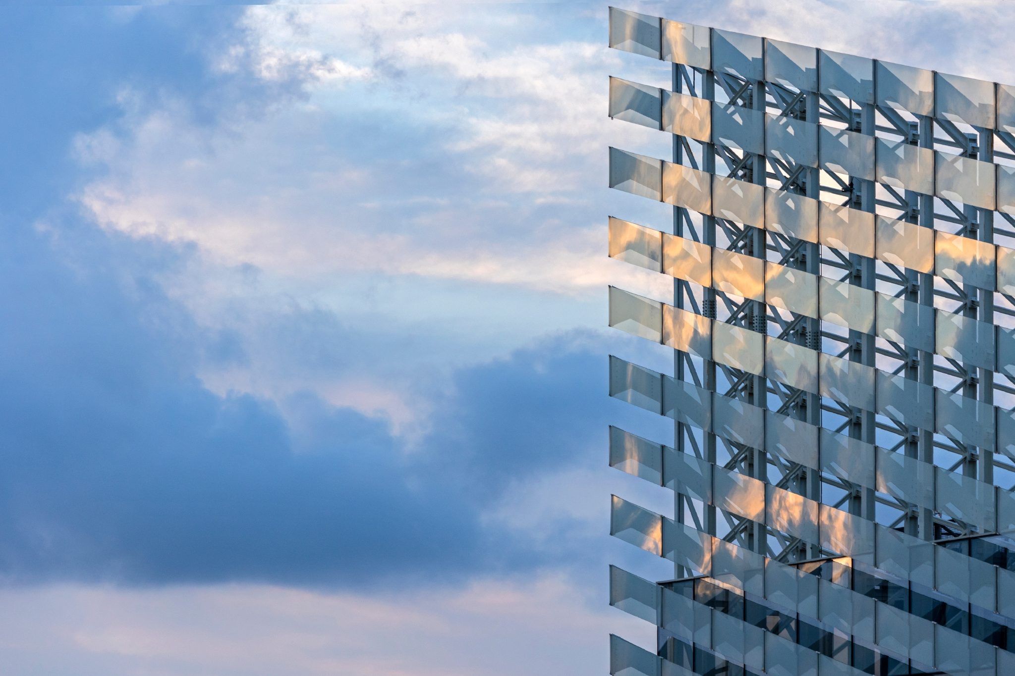 Reflective geometric building facade pictured in Puig’s third-quarter results announcement.
