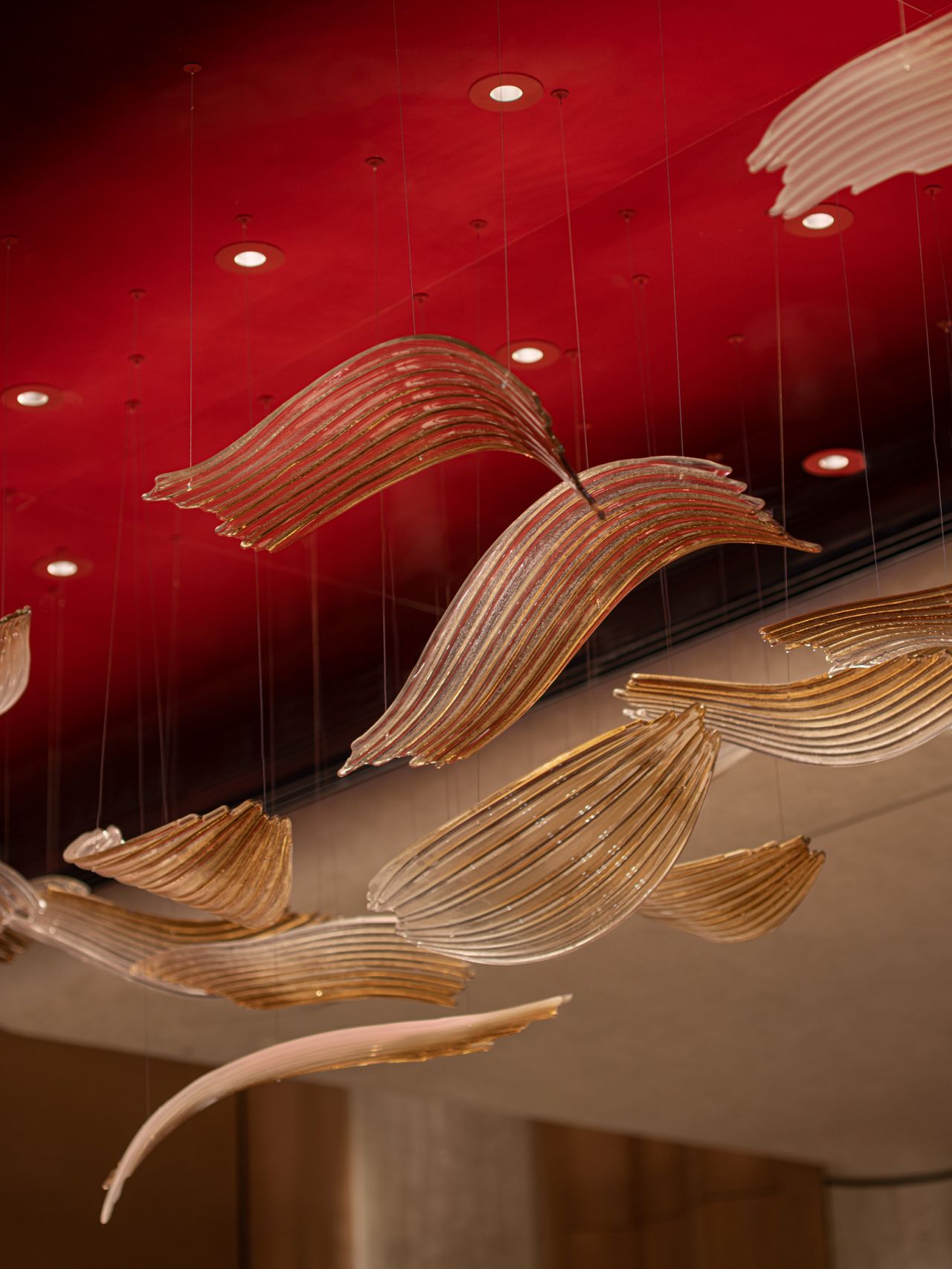 Sculptural ceiling lighting above the red interior of Qeelin House Shanghai Xintiandi
