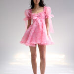 Selkie pink dress with puff sleeves, bows and a tiered skirt
