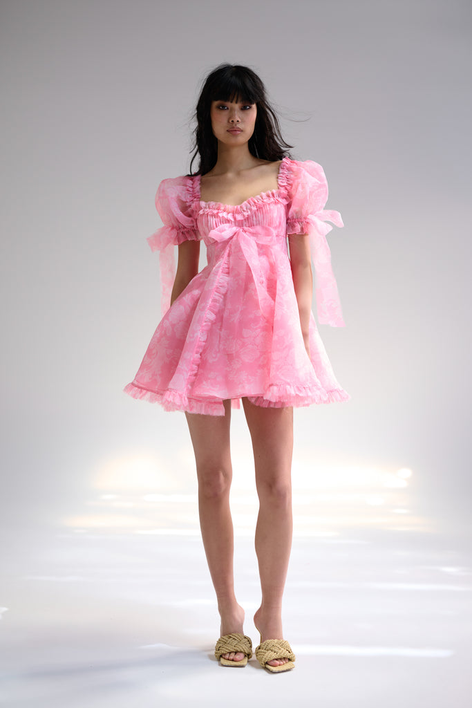 Selkie pink dress with puff sleeves, bows and a tiered skirt