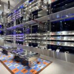 Footwear displayed on reflective shelving inside the adidas flagship.