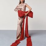 Natasha Poly with a red bow for the Holiday Fantasy campaign.