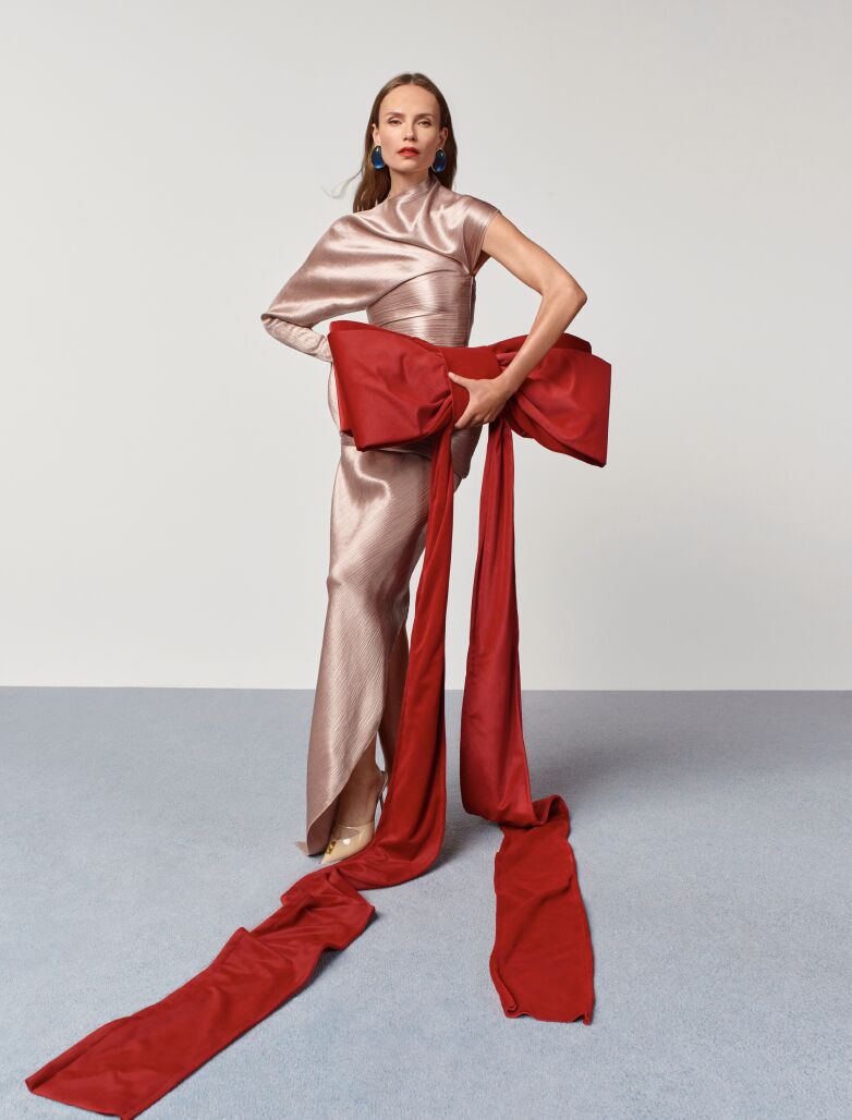 Natasha Poly with a red bow for the Holiday Fantasy campaign.