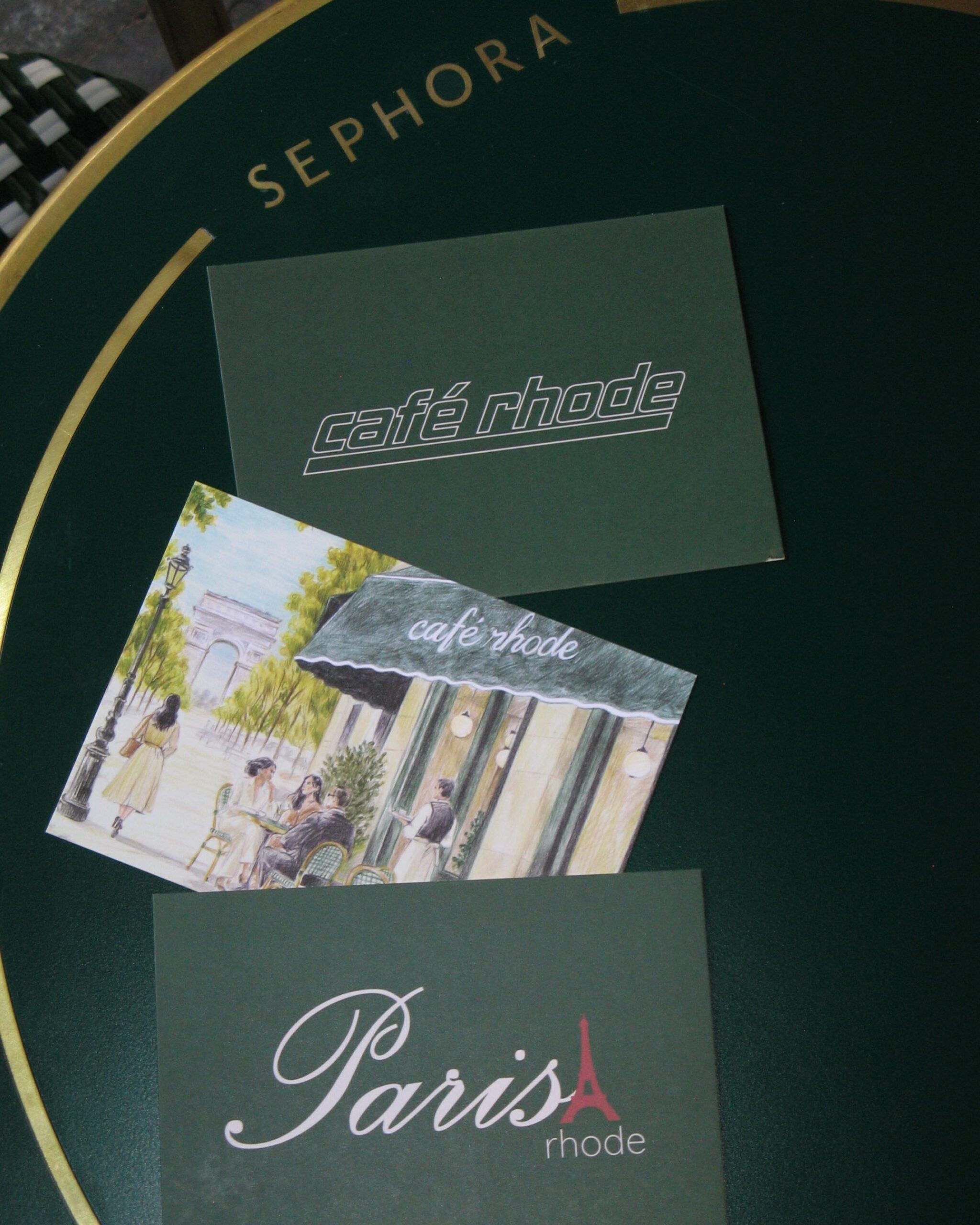 Café rhode postcards arranged on a Sephora tabletop in Paris