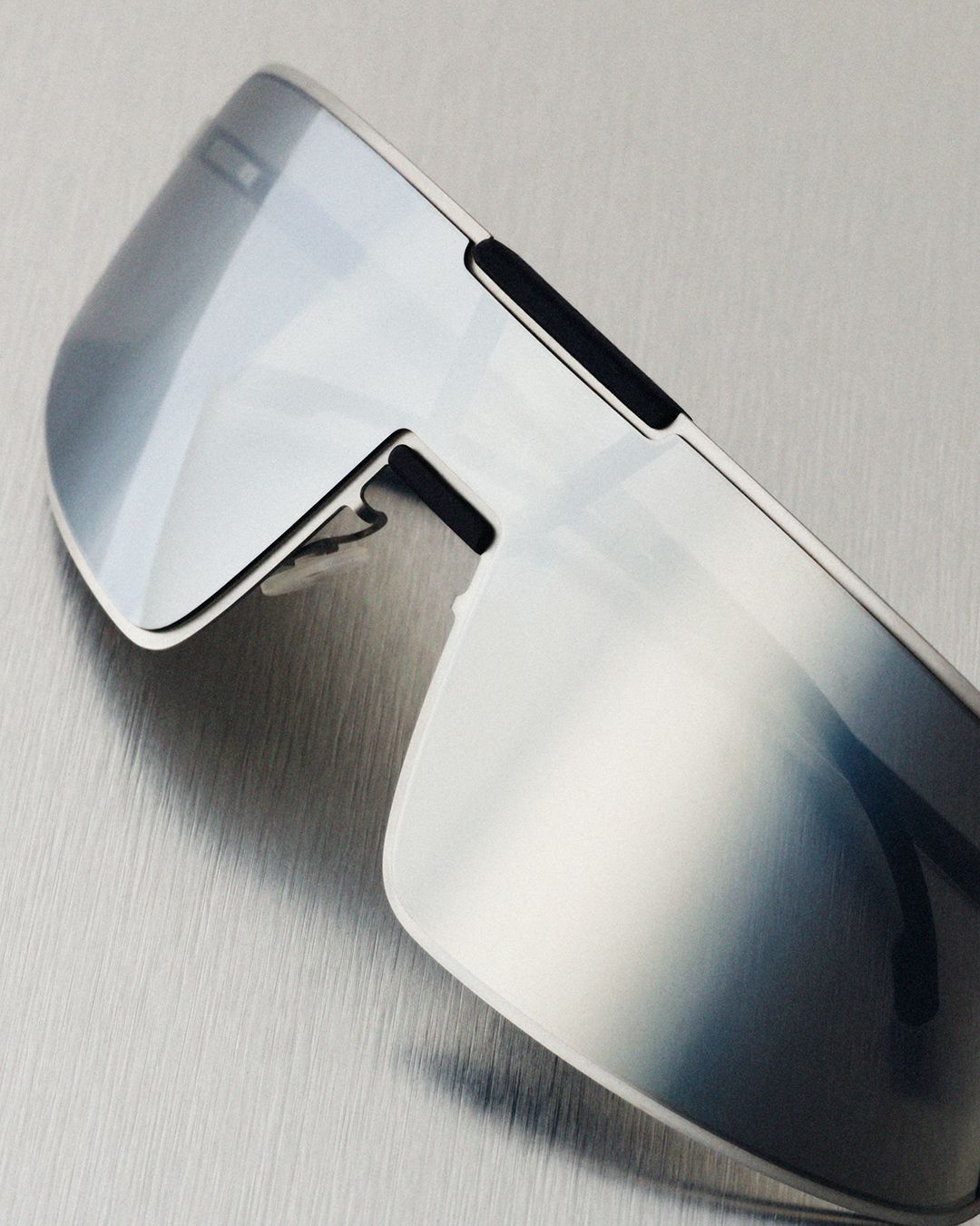 Detail of the silver MYKITA RIMOWA Visor shield sunglasses
