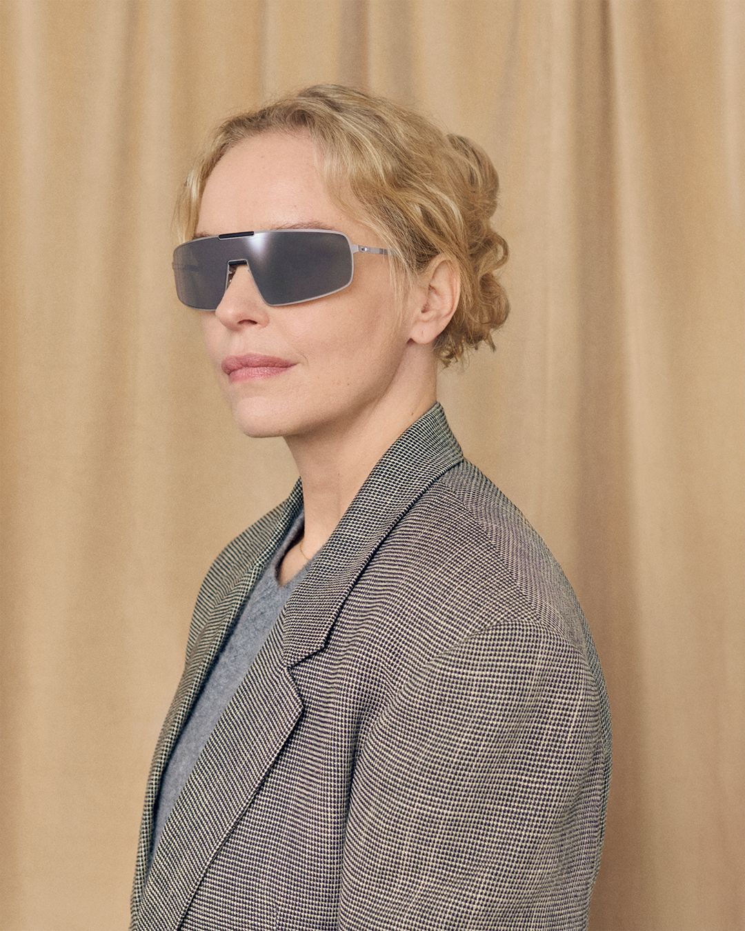 Nina Hoss wears silver MYKITA RIMOWA Visor sunglasses