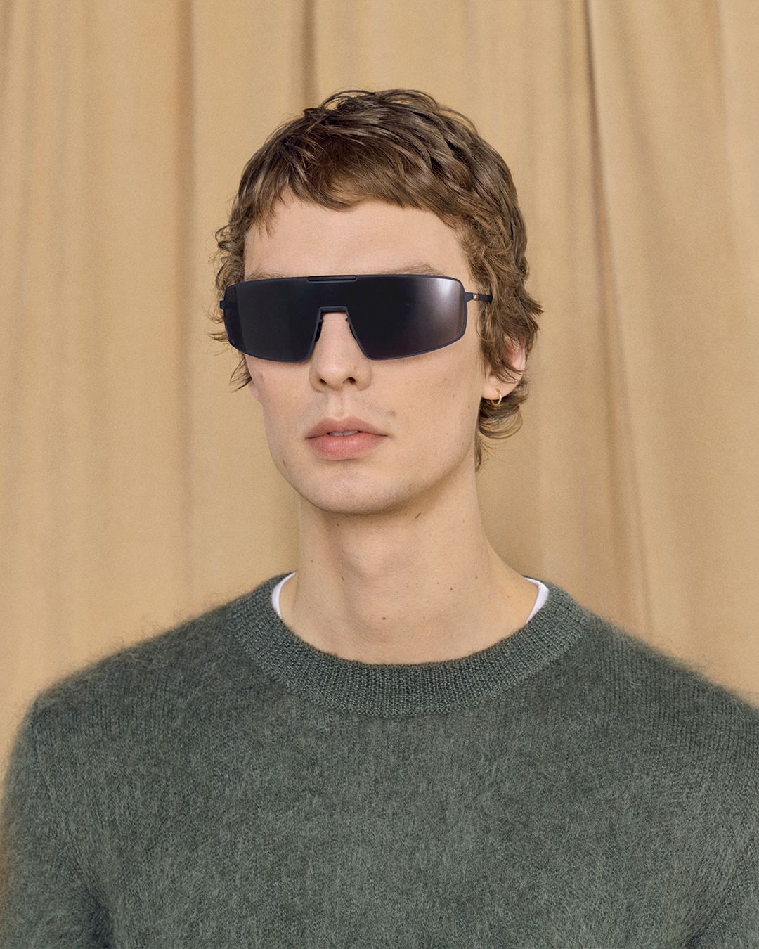 Leon Dame wears black MYKITA RIMOWA Visor sunglasses