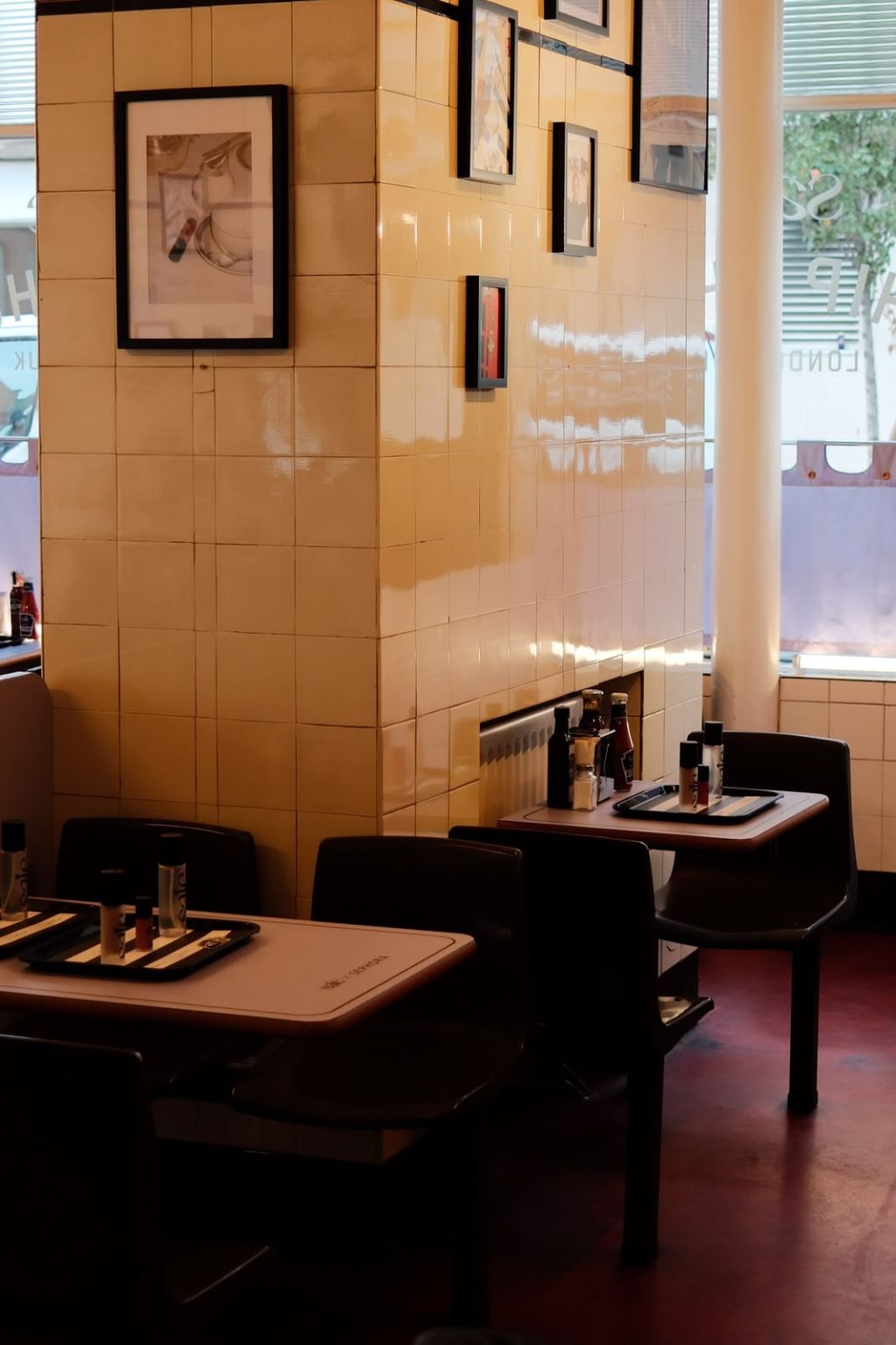 Saie products set on cafe tables beside lilac window curtains