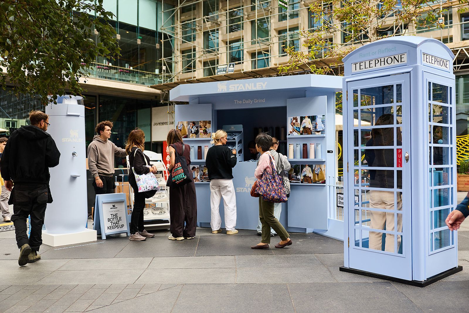 Visitors at Stanley 1913's London pop-up beside its hydration station and phone box