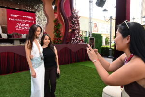 Jamie Chung poses for a photograph with a fan at StyleWeekOC