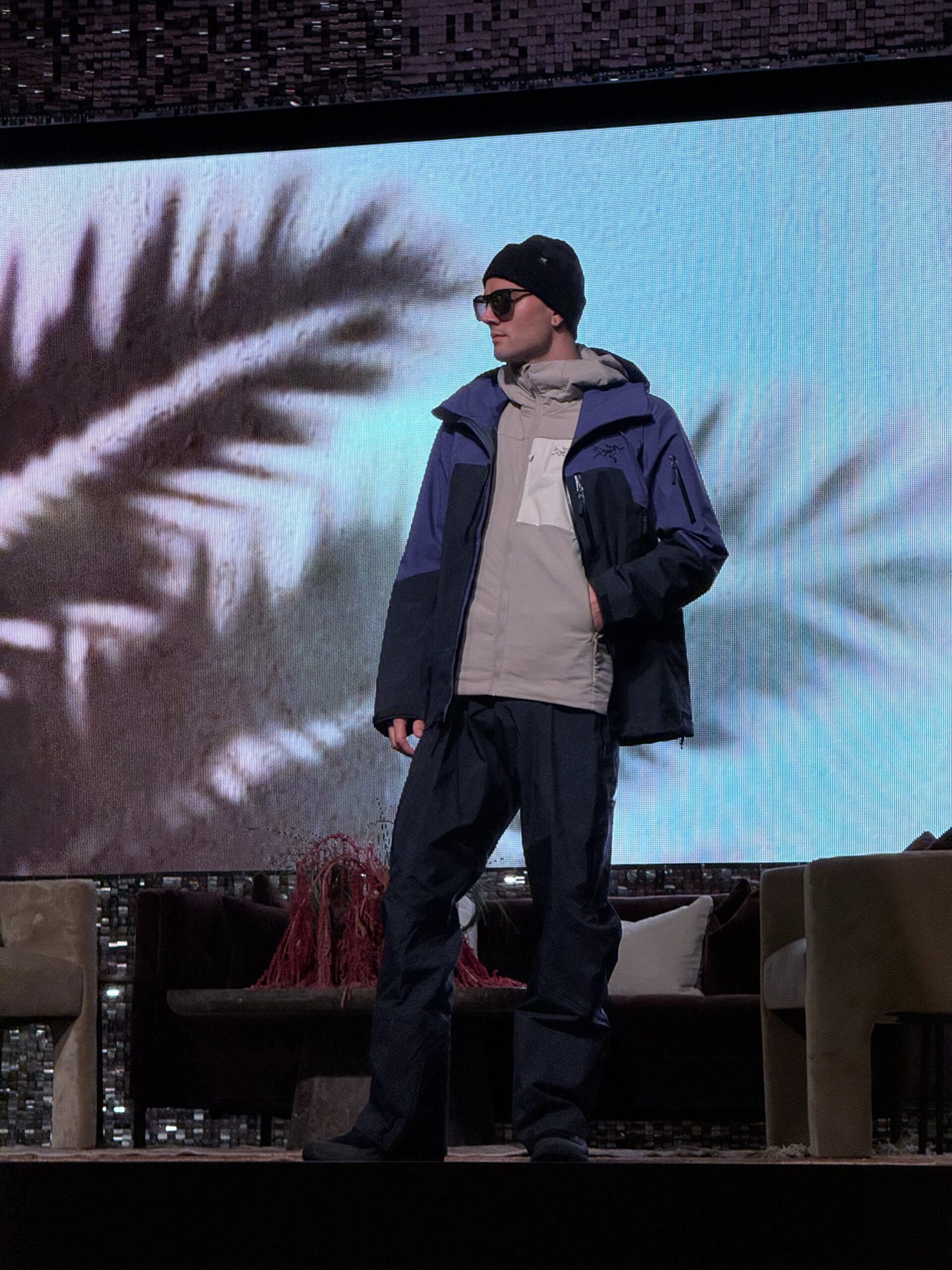 Model wearing layered outerwear on the StyleWeekOC runway