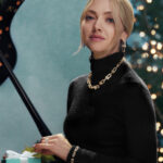 Amanda Seyfried wearing Tiffany HardWear jewelry beside a Christmas tree and a Tiffany Blue Box