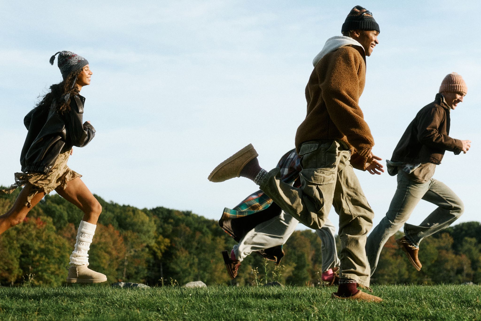 Models wearing UGG footwear and layered fall clothing outdoors