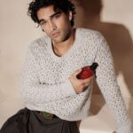 Guest holds a red Valentino fragrance bottle in a show-week portrait