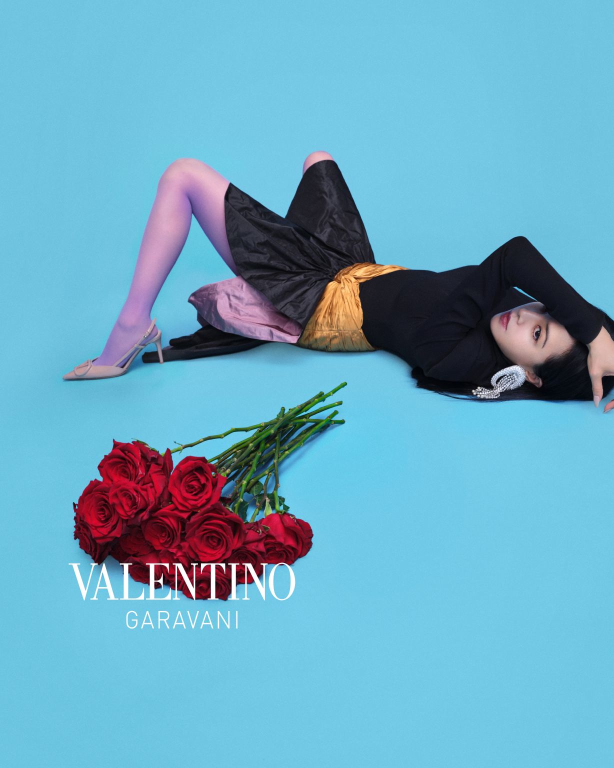 Jolin posed beside red flowers against a blue backdrop in the Valentino campaign