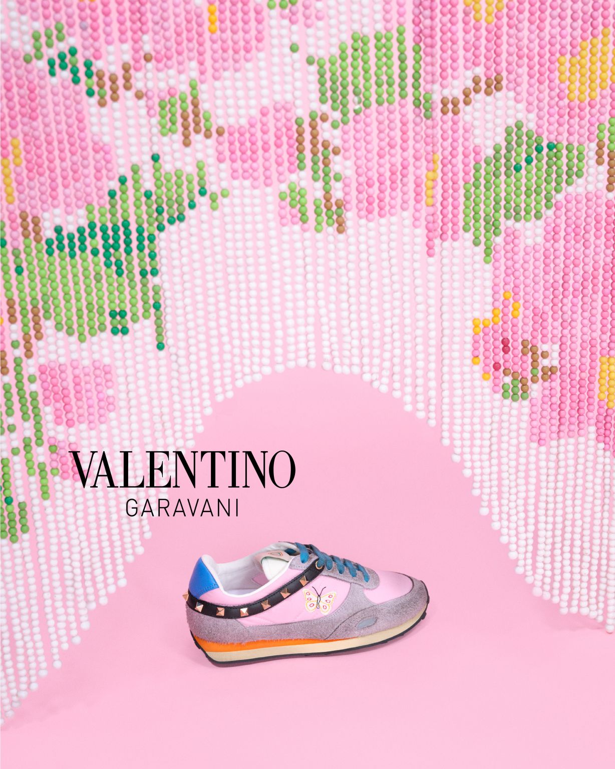 Valentino Garavani footwear beneath a beaded floral curtain