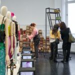 Students examine Valentino Antibiblioteca garments at the Paris resee