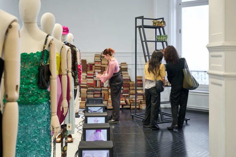Students examine Valentino Antibiblioteca garments at the Paris resee