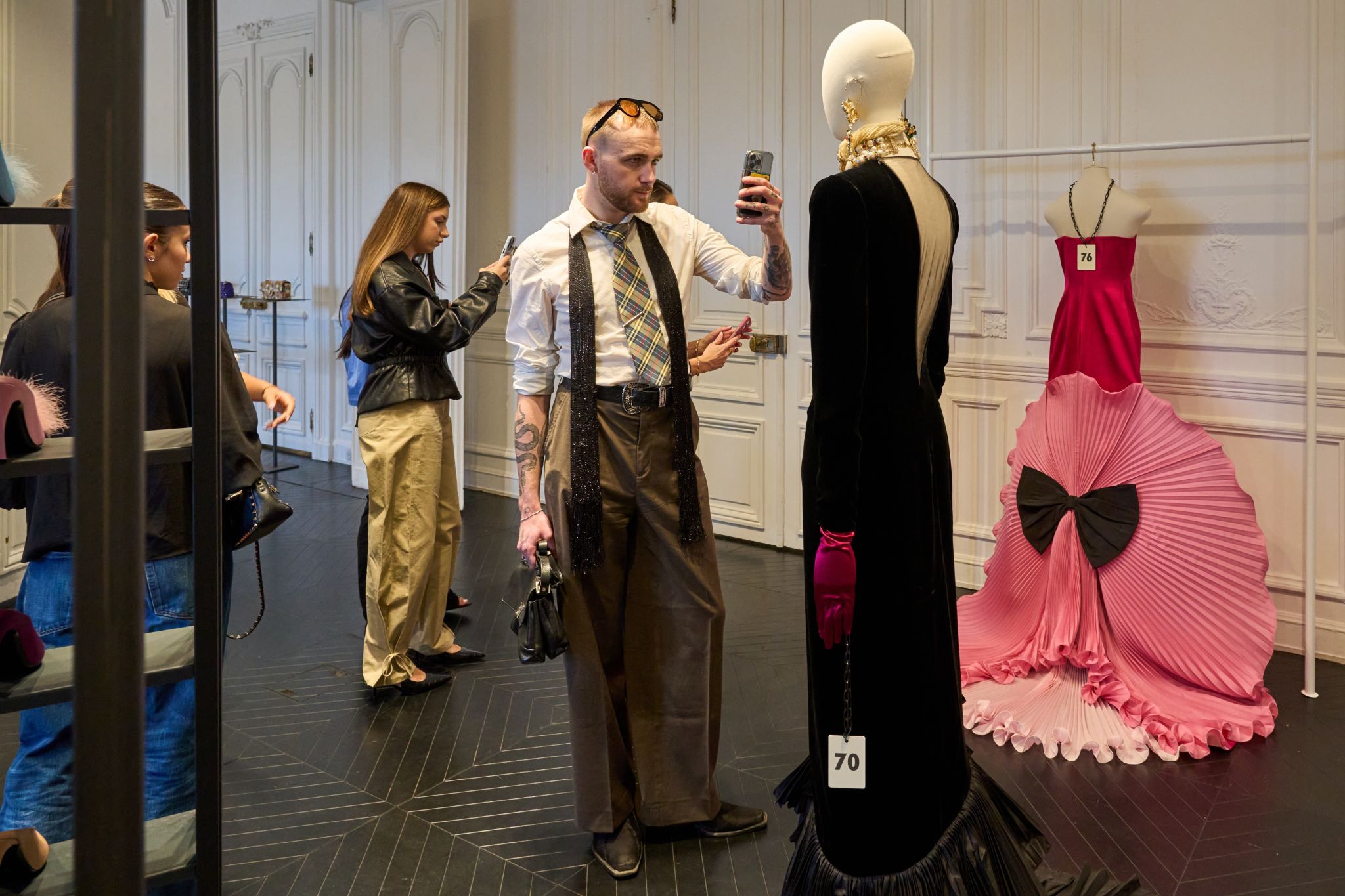 A student views garments and display materials at Valentino