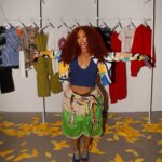 SZA at the VANSZA preview with apparel displayed behind her