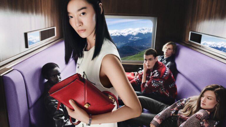 Versace Holiday 2026 cast in a lavender-seated train carriage
