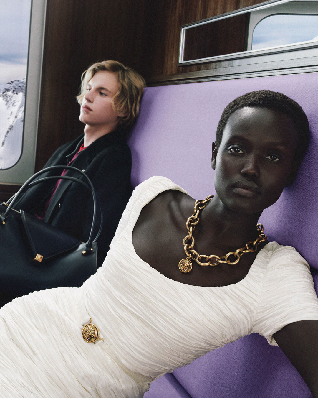 Two passengers wearing Versace in the holiday train campaign