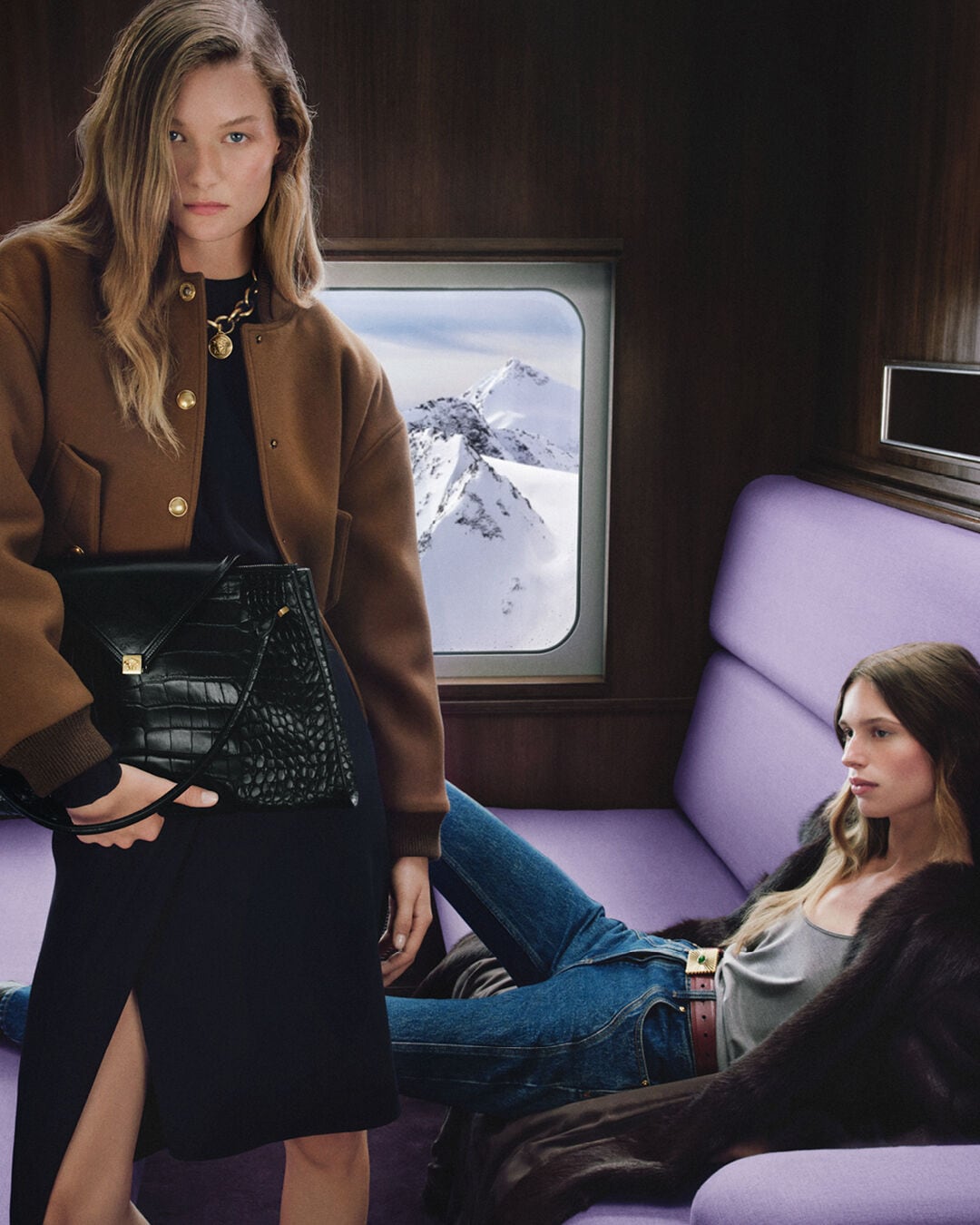 Versace holiday outerwear and handbag in the train setting