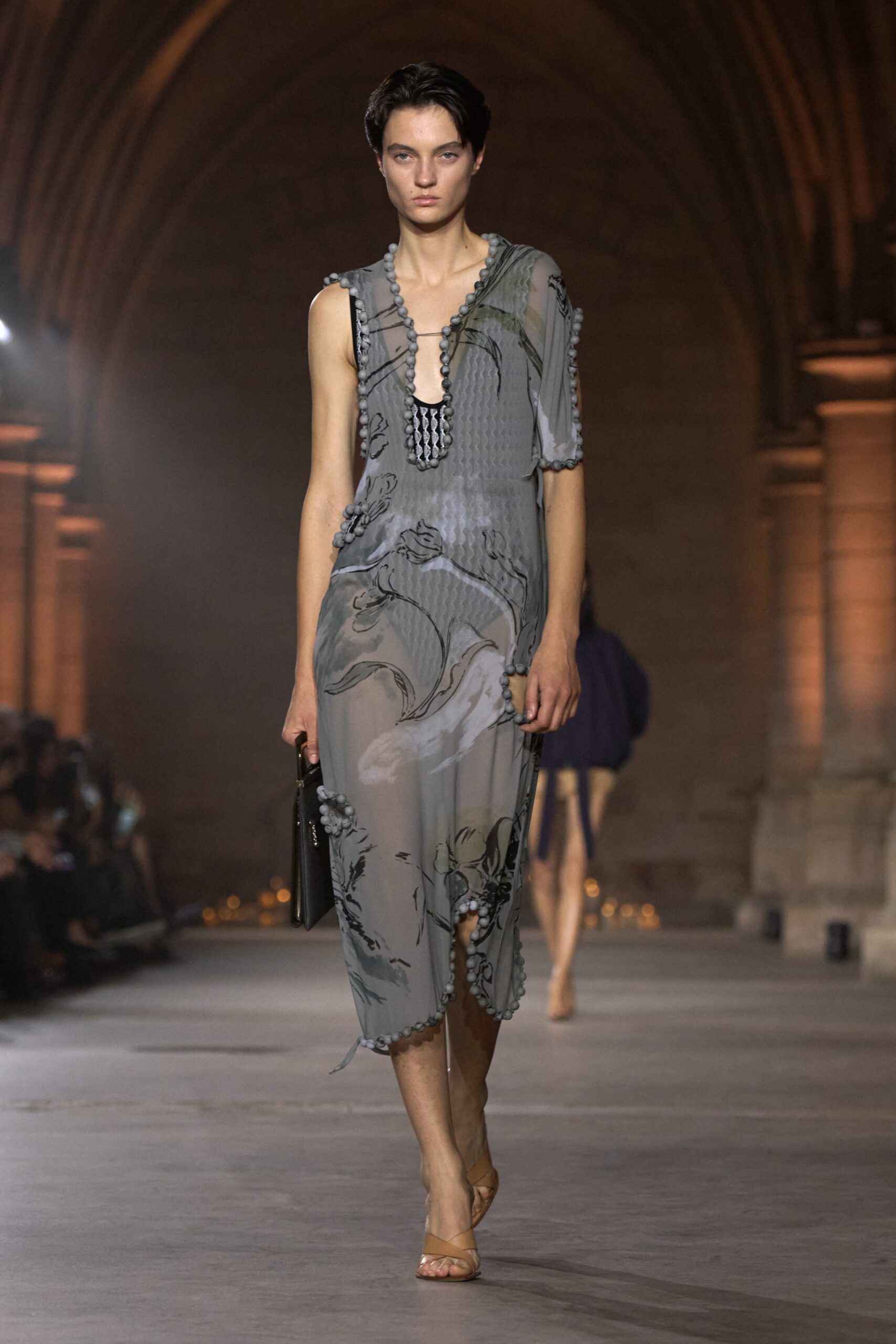 Model in a grey floral dress from the Victoria Beckham Spring Summer 2027 runway