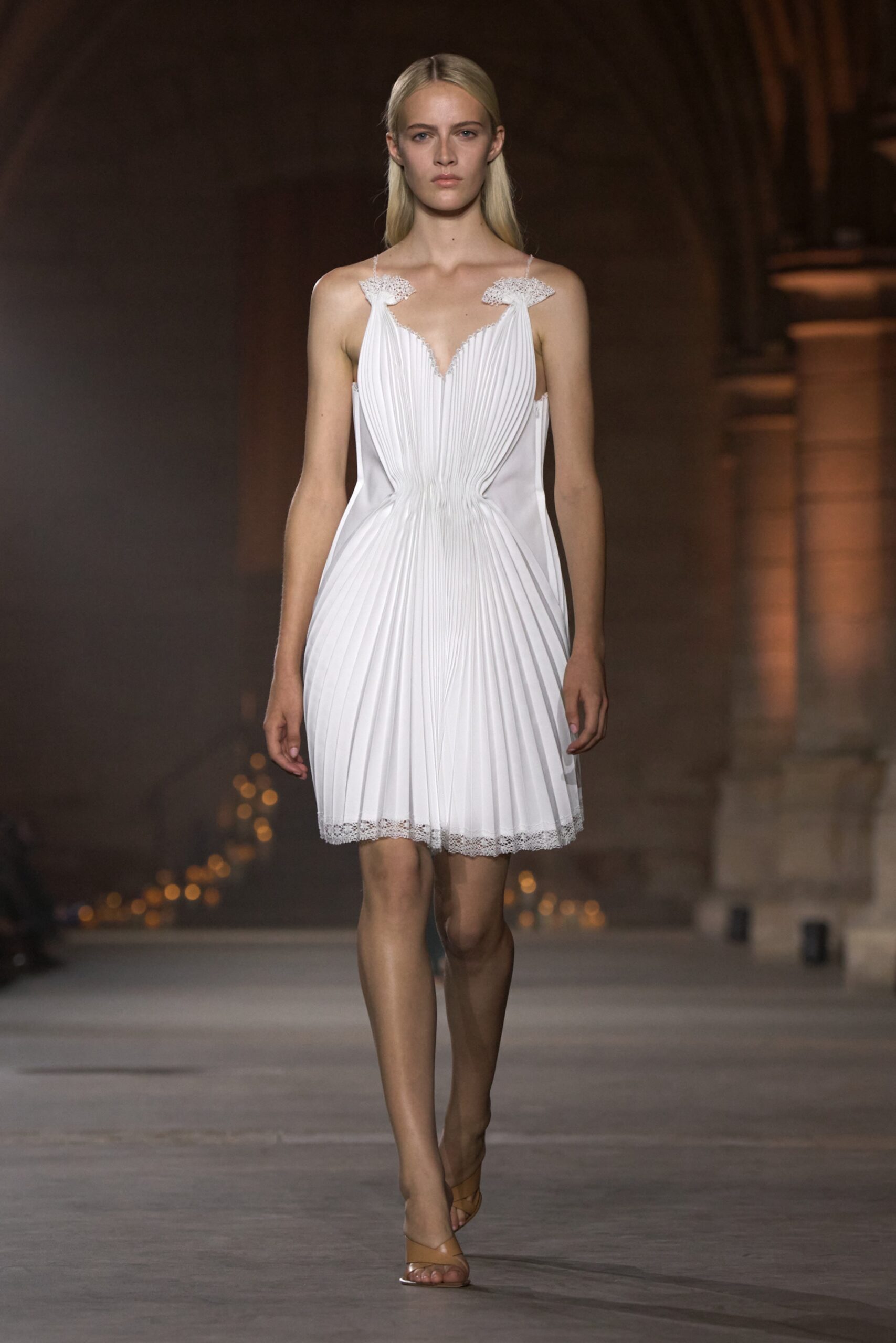 Model in a white pleated dress at the Victoria Beckham Spring Summer 2027 runway show